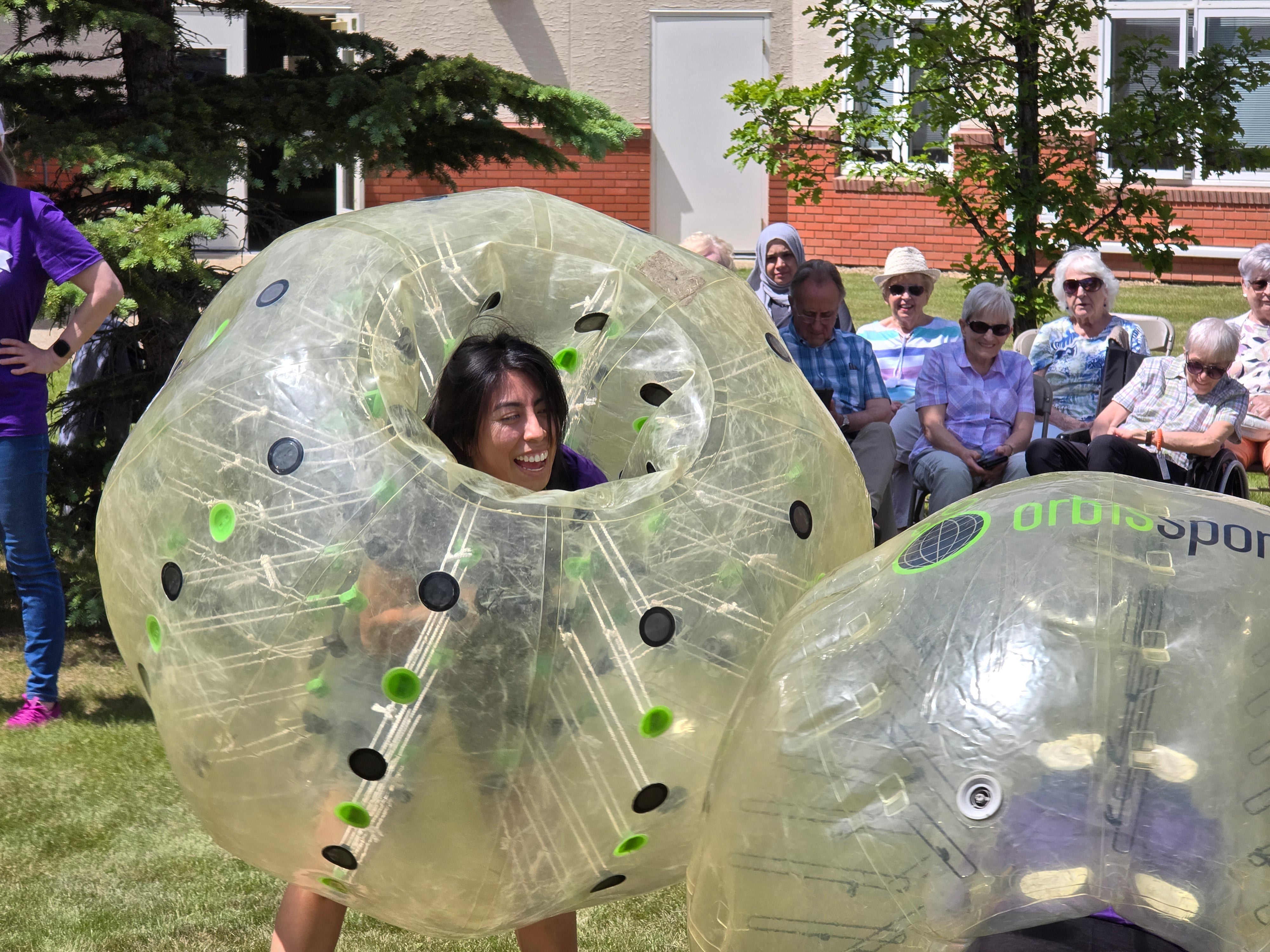 Head to head two players battle in zorb bubble suits for and Edmonton Community days event in 2024